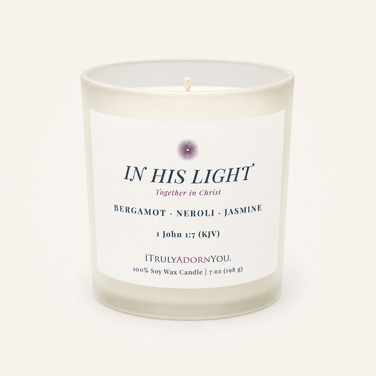 A frosted glass soy wax candle with a white label reading 'IN HIS LIGHT' and 'Bergamot - Neroli - Jasmine' by iTrulyAdornYou, photographed on a clean off-white background.