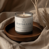 Selah Daybreak candle on a wooden tray with a neutral background