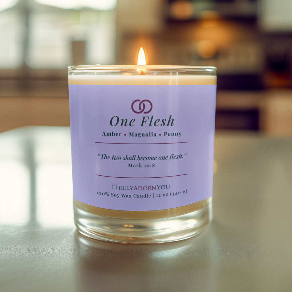Candle with a purple label that says One Flesh and Mark 10:18 with a blurred background