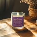 Perfect Unity candle with a purple label on a wooden surface with a blurred background